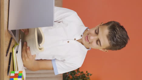 Vertical-video-of-Boy-reading-a-book.